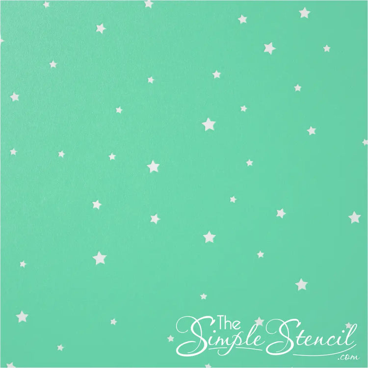 Collection of small white star decals on a green wall