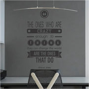 Steve Jobs Crazy Enough To Change The World Quote as a wall quote decal placed over a home office desktop.