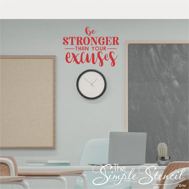 Motivational quote on a wall in a school classroom setting with a clock and laptop.