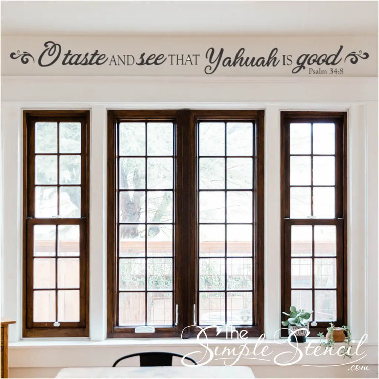 "Taste and See That Yahuah is Good" wall decal displayed on a living room wall, surrounded by other inspirational décor.