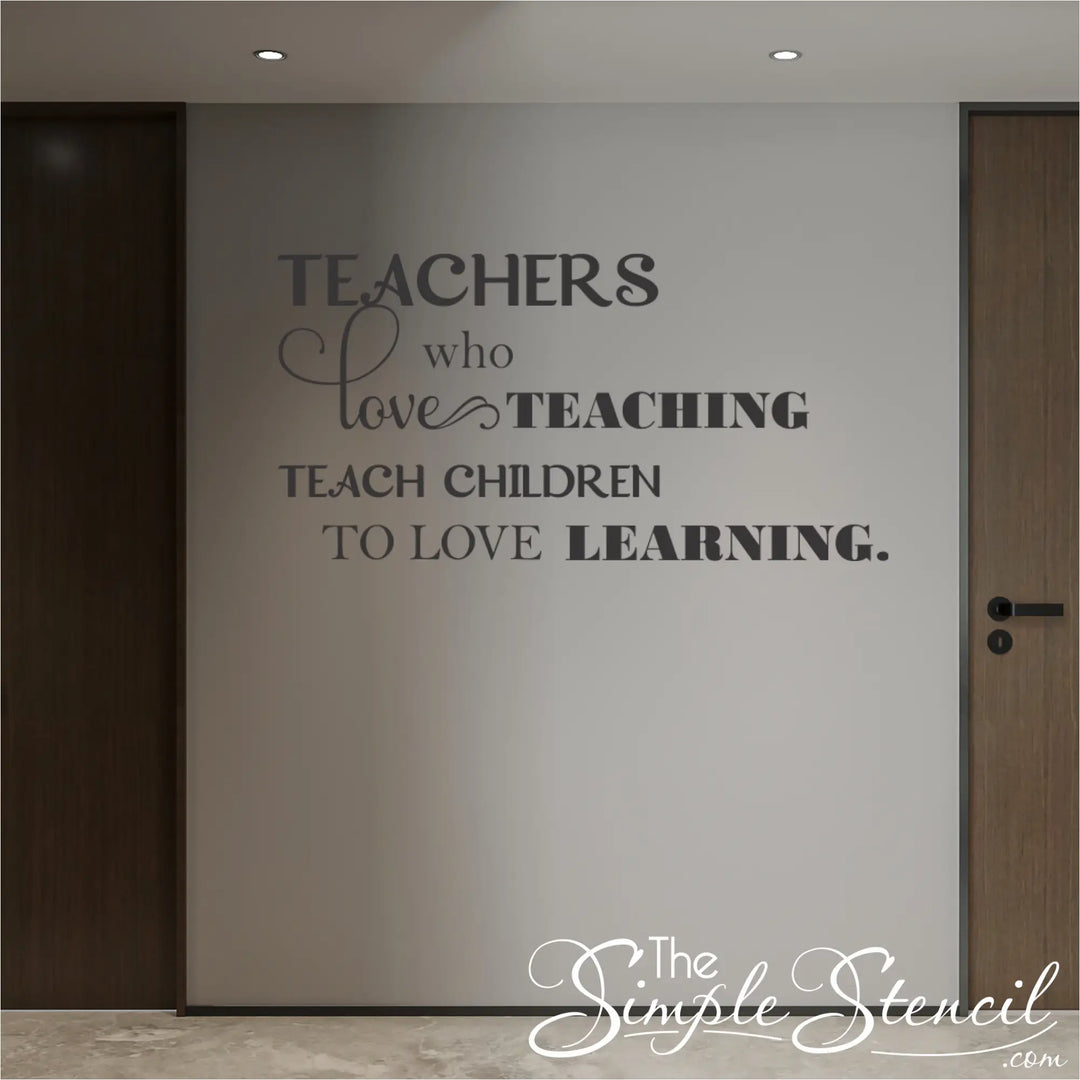 Large format school hallway wall decal 'Teachers who love teaching teach children who love learning' in dark grey vinyl on a neutral wall between classroom doors.