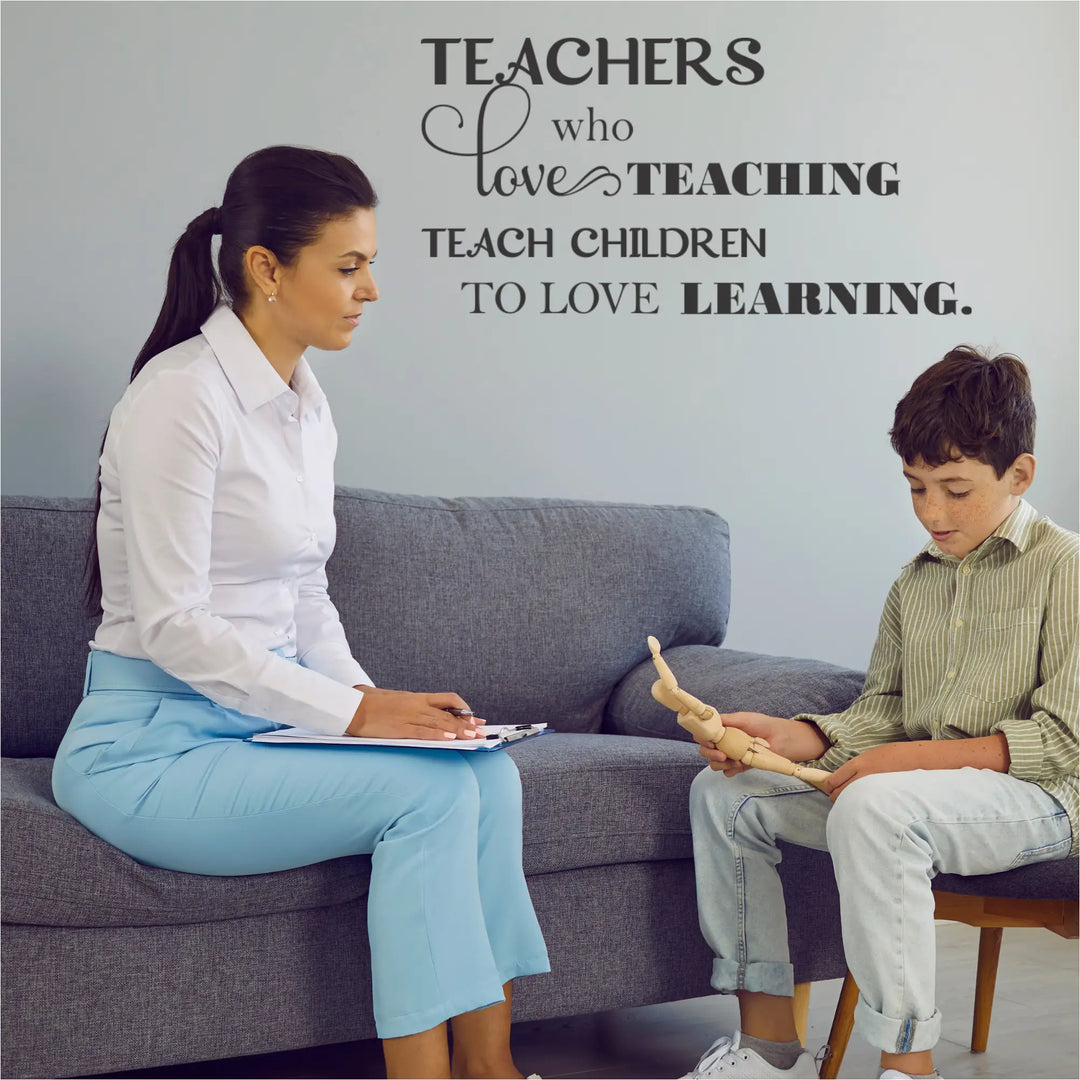 Professional vinyl wall decal with the quote 'Teachers who love teaching teach children who love learning' applied to a light blue wall in a school guidance office.