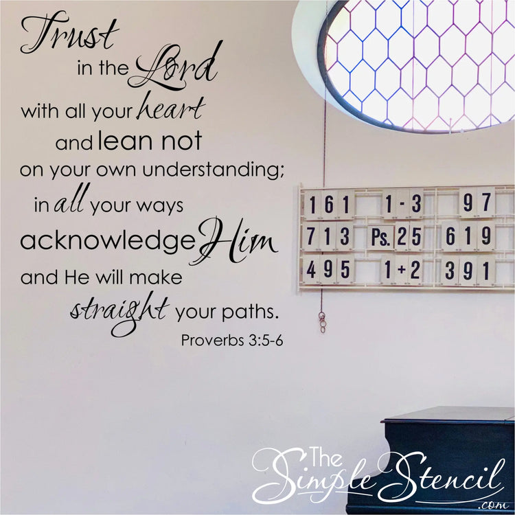 The bible verse wall sticker by The Simple Stencil shown on a church wall near the hymnal display that reads: Trust in the Lord with all thine heart and lean not on your own understanding; in all your ways acknowledge Him and He will make straight your paths. Proverbs 3:5-6