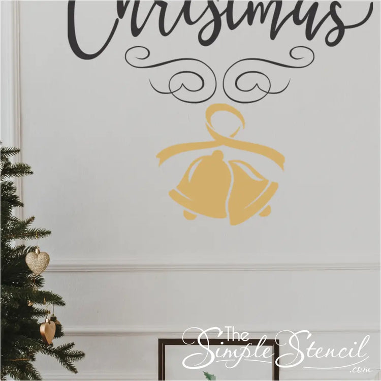 Twin bells Christmas wall decal in gold on wall by christmas tree under a larger Merry Christmas wall decal
