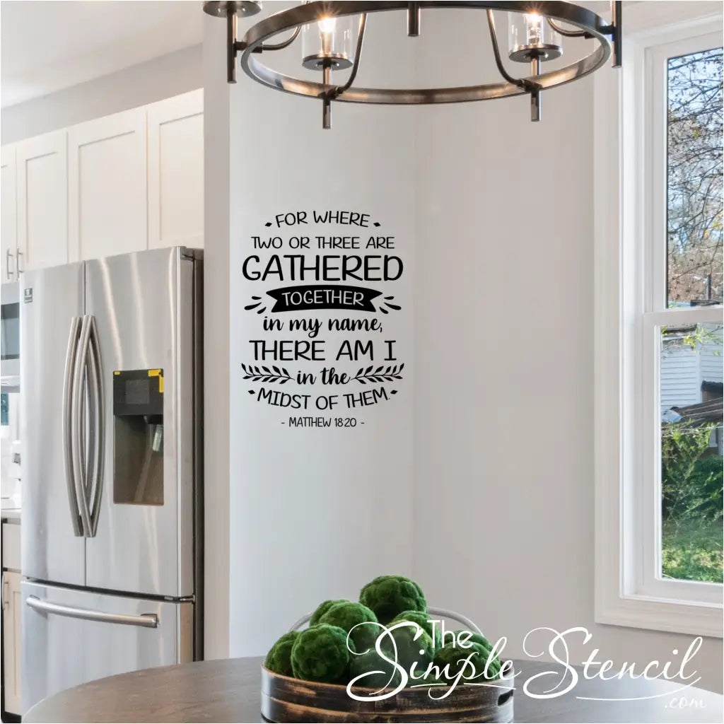 "Where Two or Three Are Gathered" wall decal in black vinyl on a light-colored wall in kitchen dining room area. 