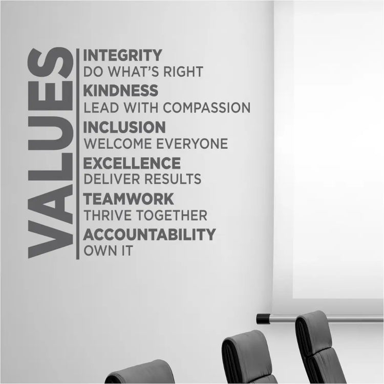 Gray values wall decal with bold sans-serif text promoting corporate principles like integrity for positive workspaces