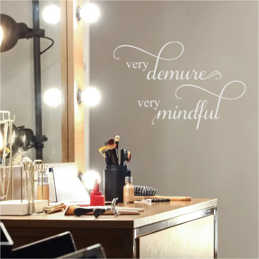 "Very Demure Very Mindful" wall decal in elegant script above a vanity table.