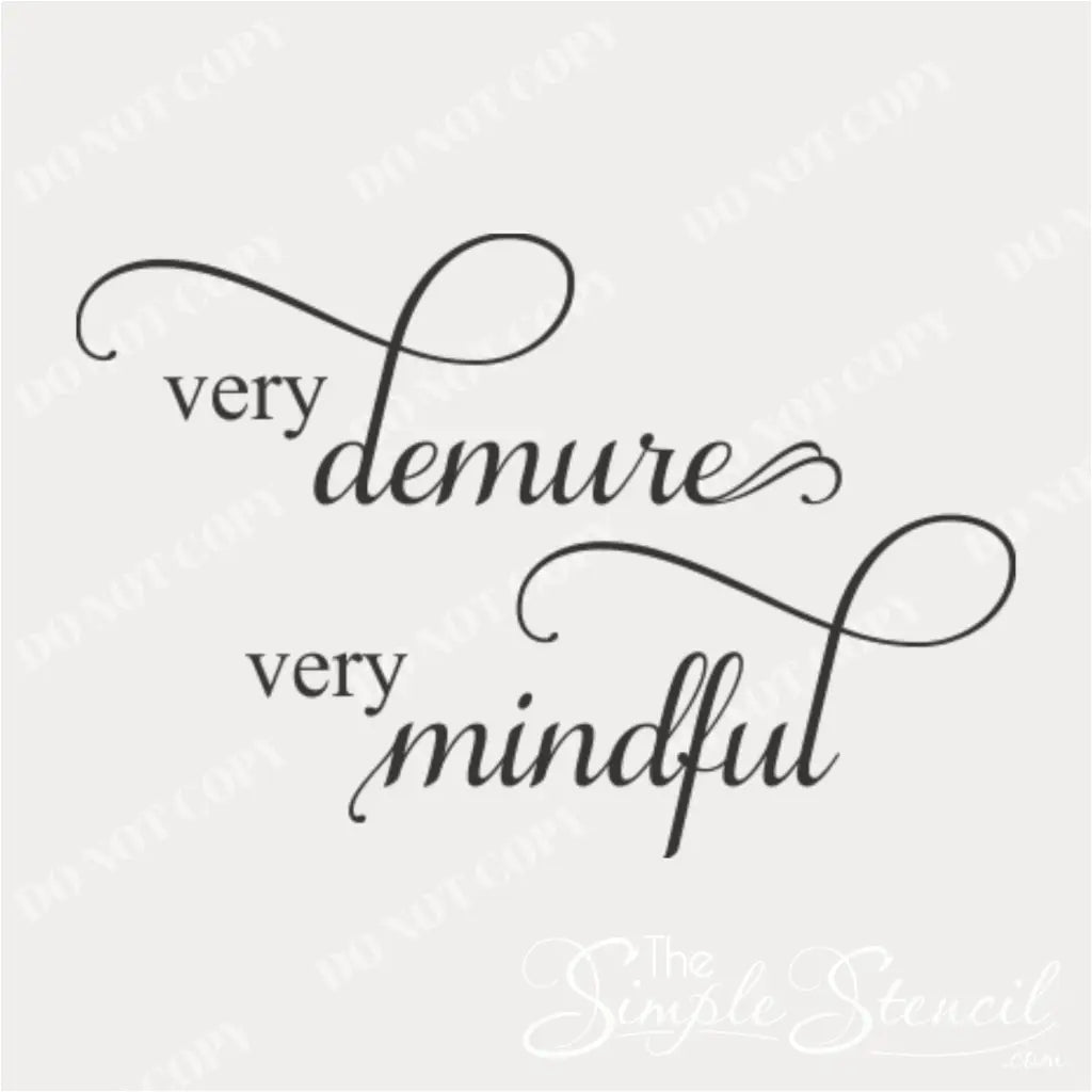 Close-up of "Very Demure Very Mindful" wall decal in black vinyl on a white wall.