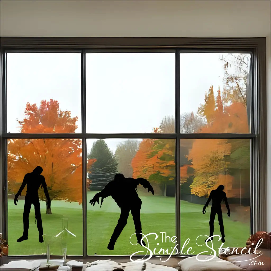 A set of three black walking zombie silhouettes in varying sizes on a large bay window, creating a scene of zombies approaching from a distance.