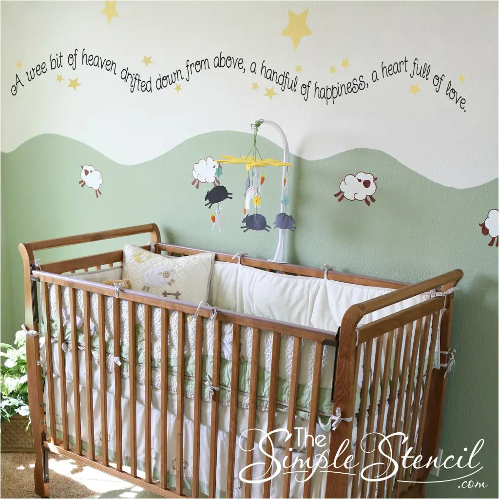 A cute wall quote decal by The Simple Stencil that reads: A wee bit of heaven drifted down from above, a handful of happiness, a heart full of love. Perfect DIY decor for baby nursery walls!