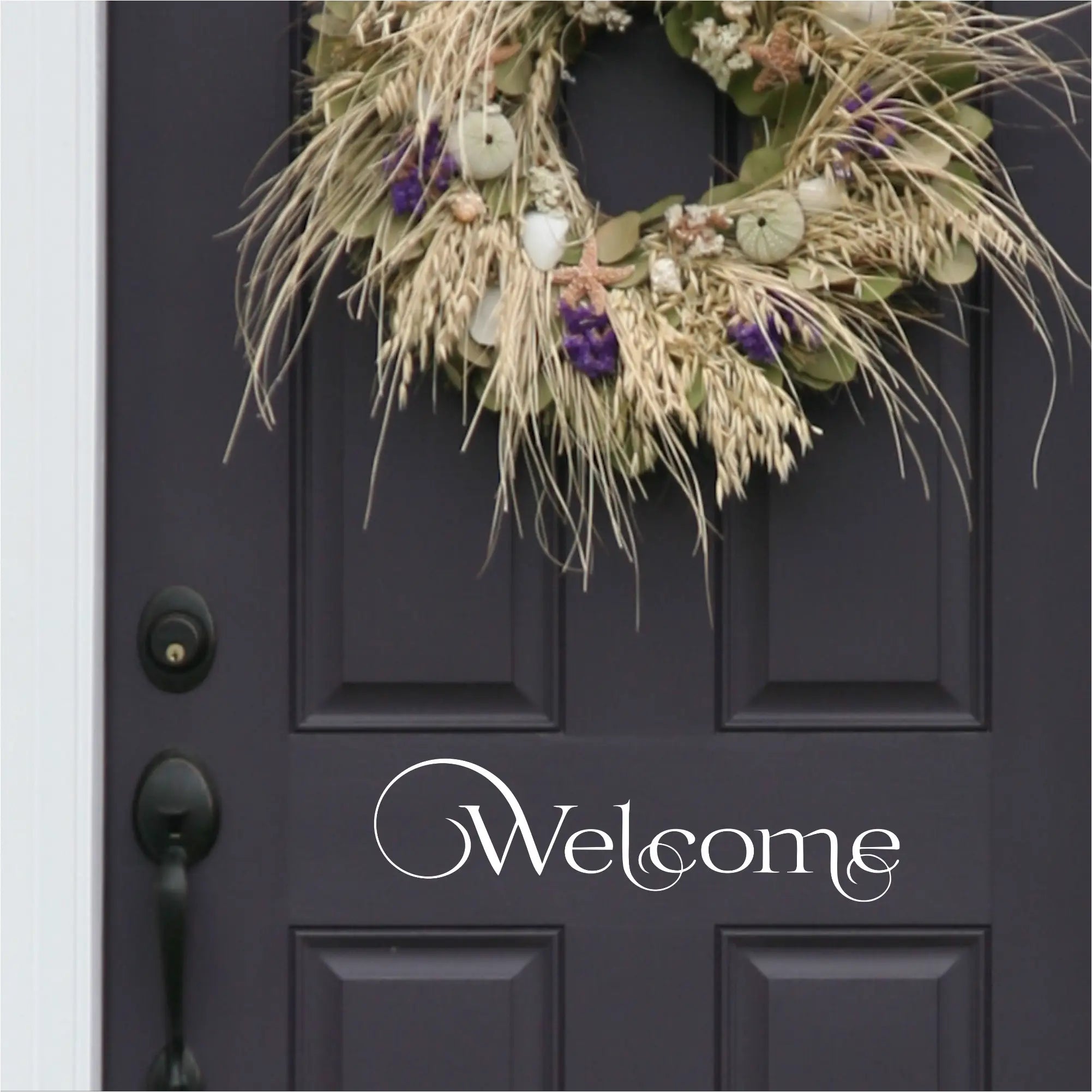Welcome Decal in a swirly pattern installed on a black door using white vinyl decal transfer by The Simple Stencil. So easy to install and it's removable. Looks painted on because it doesn't have a clear background like others. 
