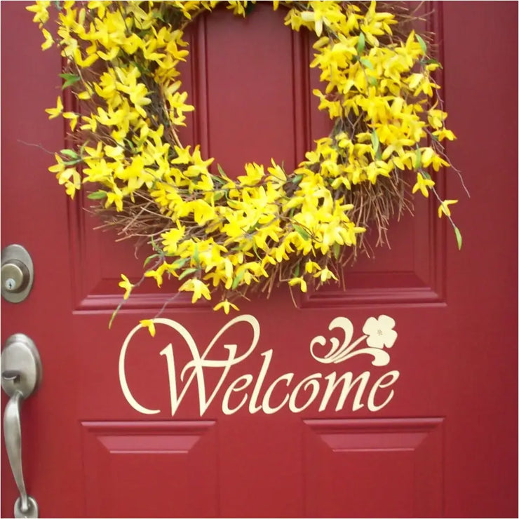 Welcome decal in a classic style with flower embellishment shown installed on a red door using the ivory color. Looks painted on but it&