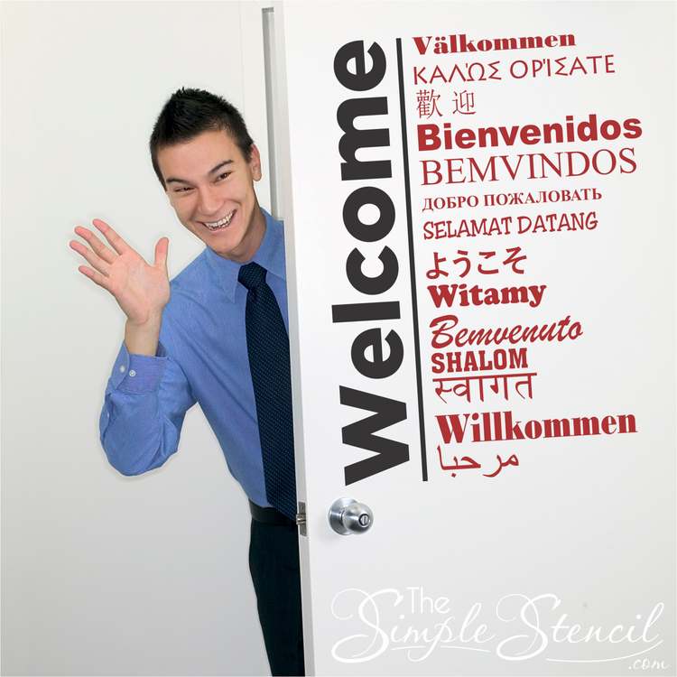 Welcome wall decals translated into 15 different languages displayed on an entry door.