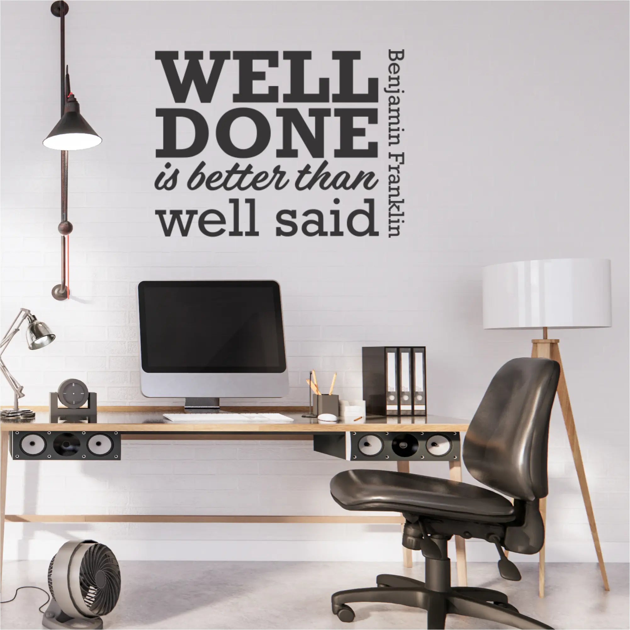 "Well Done is Better Than Well Said" wall decal displayed in a modern office.