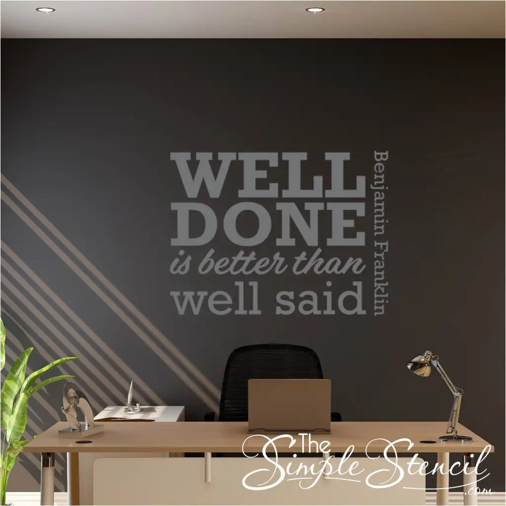 "Well Done is Better Than Well Said" wall decal applied above a desk.