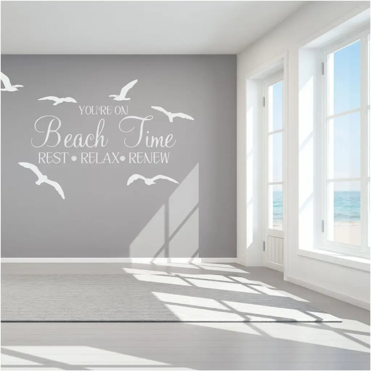 You're on Beach Time - Rest Relax Renew - a beautiful wall decal on a beach house wall surrounded by seagull wall decals to encourage a relaxing atmosphere in a vacation rental seaside home. 